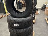 four tires stacked on pallets in a warehouse