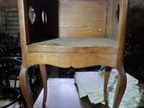 a wooden table with a chair on it in a room