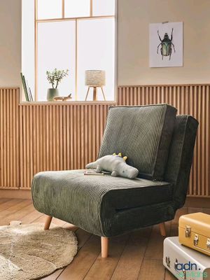 a chair with a stuffed animal on it in a living room