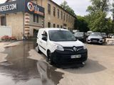 a white van that is parked in front of a building