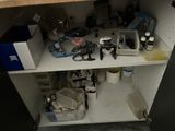 a cabinet with a lot of clutter on top of it