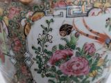 a vase with a gold handle on a white table