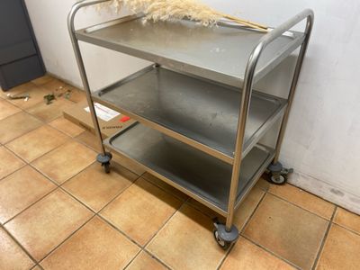 a metal cart with a broom on top of it