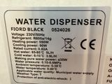 the back of a water dispenser with a sign stating that it is rated volt