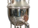 a silver tea pot on a stand on a white background
