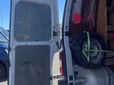a white van with a flat tire in the back of it
