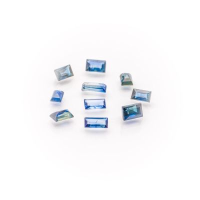 a group of blue and white glass beads sitting on top of a white surface