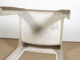 a small white chair with a number on the back