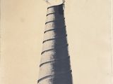 a black and white photo of a tower with a kite on top of it