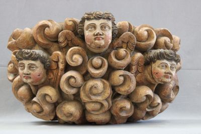 a sculpture of a group of people made of wood