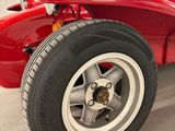 an image of a red race car in a garage