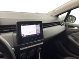 the interior of a car with a touch screen and steering controls