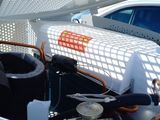 a car that is parked under a pergol roof