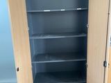 a black cabinet with shelves in the corner of the room