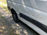 a white van that is parked on the side of the road