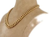 a close up of a mannequin torso with a gold chain on it