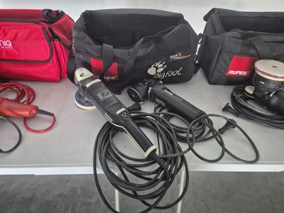 a table with a bunch of tools and a bag on it