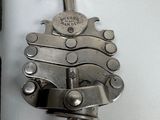 a bottle opener with a corkscrew attached to it