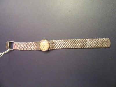 an image of a wrist watch on a black surface