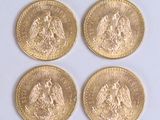 four gold coins with the image of a man and a woman on them