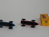 two toy cars that are sitting next to each other