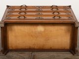 an old wooden trunk sitting on top of a floor next to a white wall