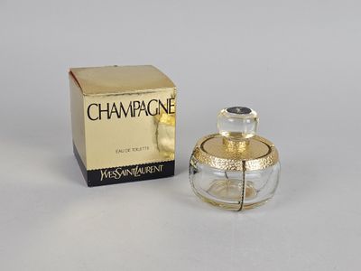 the small bottle of perfume is next to the box on the table