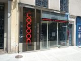a red sign on the glass door of a building