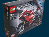 a box of lego technics with a red motorcycle in it