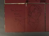 a drawing of a man in a suit and tie on a red piece of paper