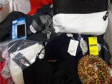 a pile of clothes and other items on a bed