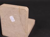 a small piece of cardboard with a sticker on it