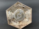 a metal object with a clock on it on a table