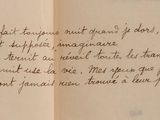 an open book with a handwritten poem on it sitting on top of a table