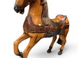 statue of a horse with a saddle on its back on a white background