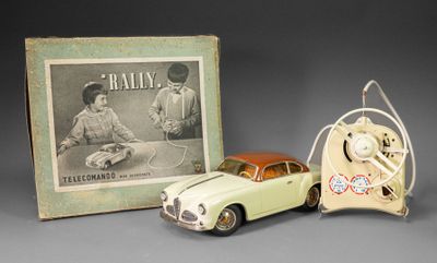 a small toy car next to a picture of a man