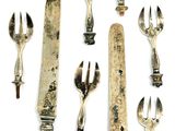 a lot of forks and spoons that are on the table