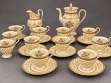 many cups and saucers that are sitting on the table