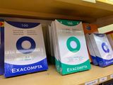 boxes of exam papers on a shelf in a library