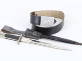 a leather belt with two knives and a belt with a buckle