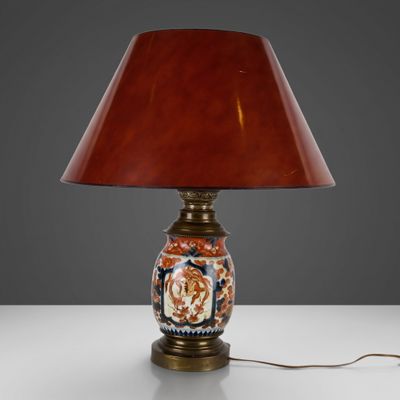 an image of a lamp with a red shade on a table