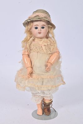 a doll that is wearing a dress and a hat