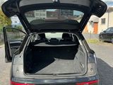 the back of a car with its trunk open in a parking lot