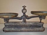 a metal scale with two bowls on it on a table