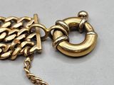 an image of a close up of a gold chain with a ring on it