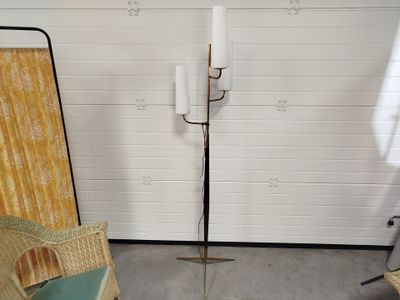 a floor lamp that is on a stand in a room