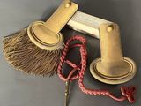 a broom, a brush, and some other items on a table