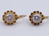 a pair of diamond earrings on a white background