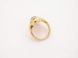 a gold ring with a white stone in the middle