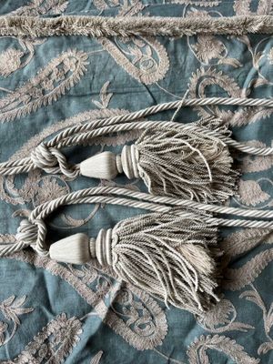 two tassels that are laying on a bed
